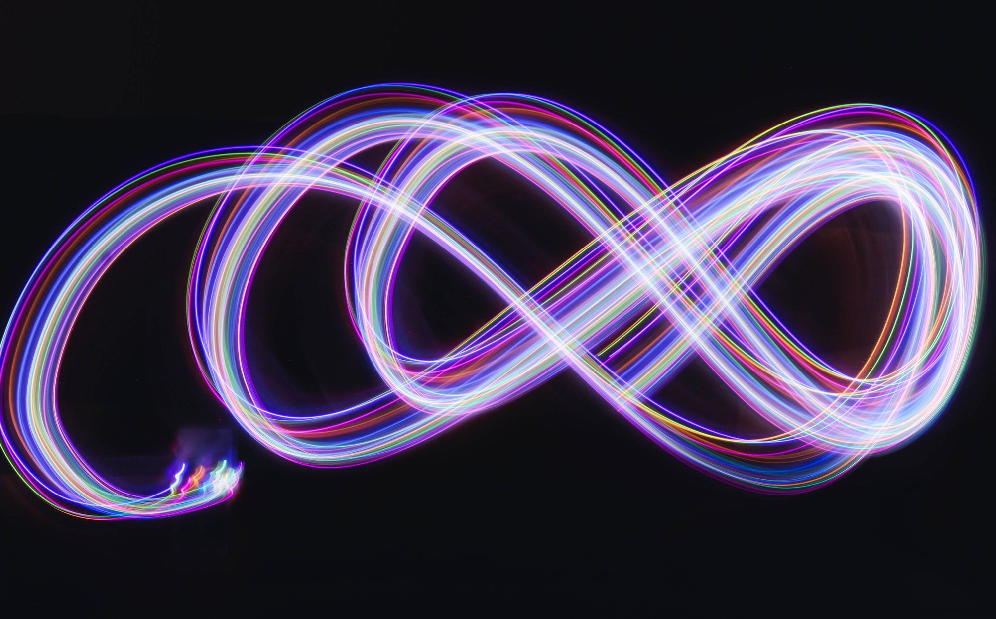 An infinity symbol drawn in flowing neon light