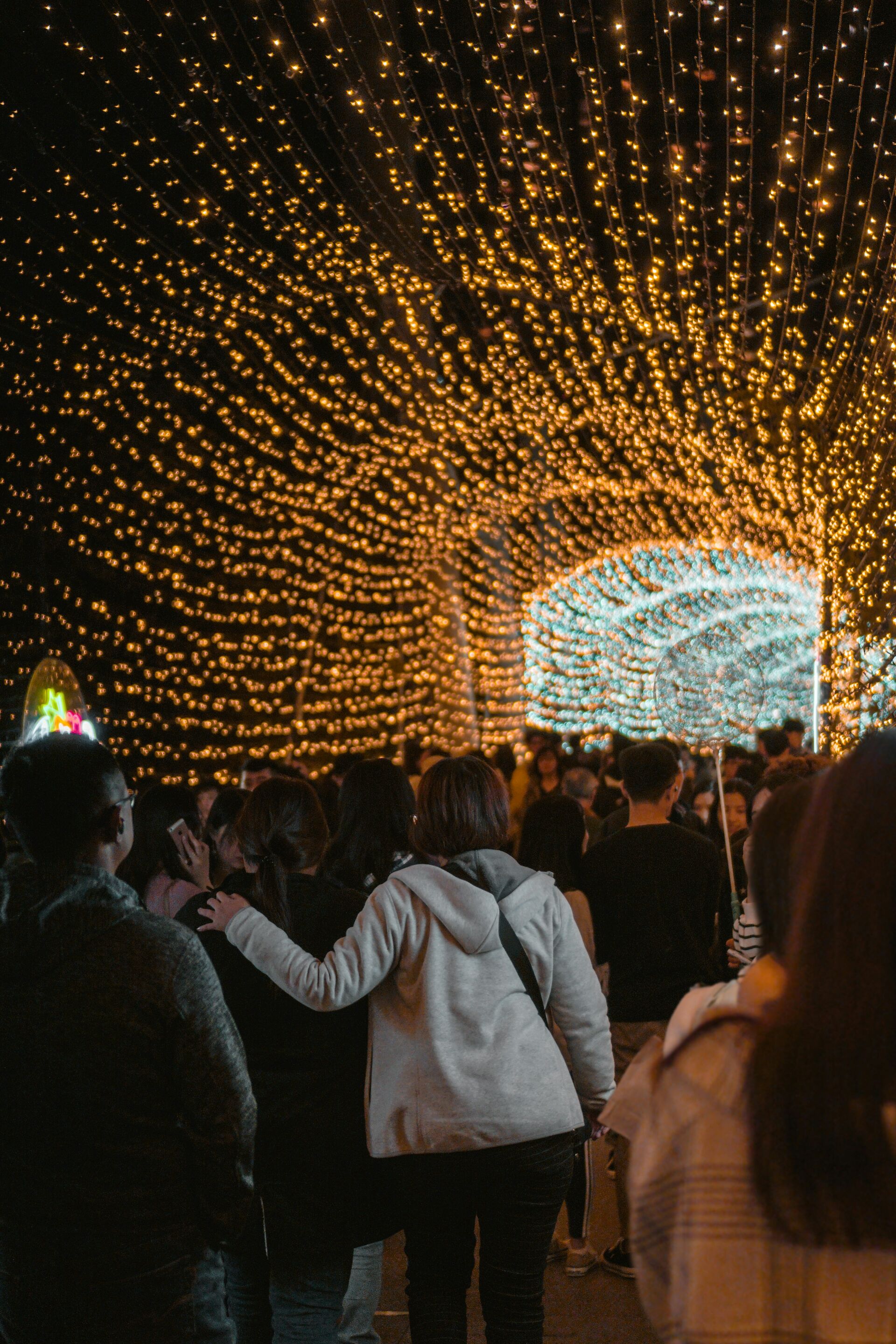 A gathering beneath a canopy of golden lights