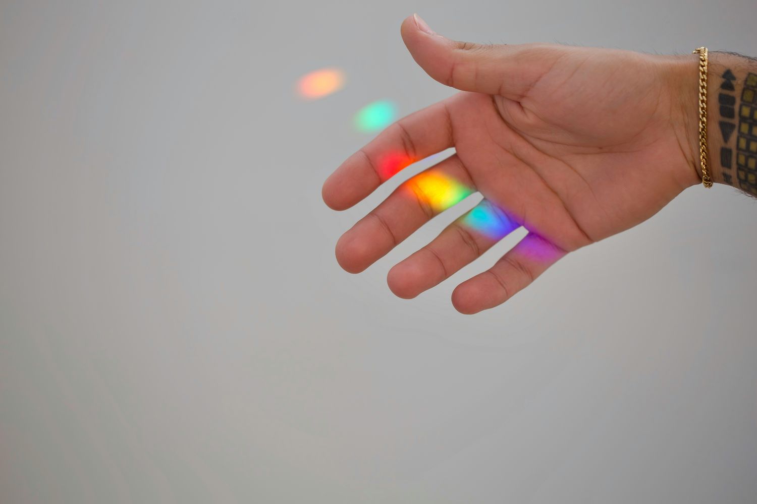An open hand catching rainbow light